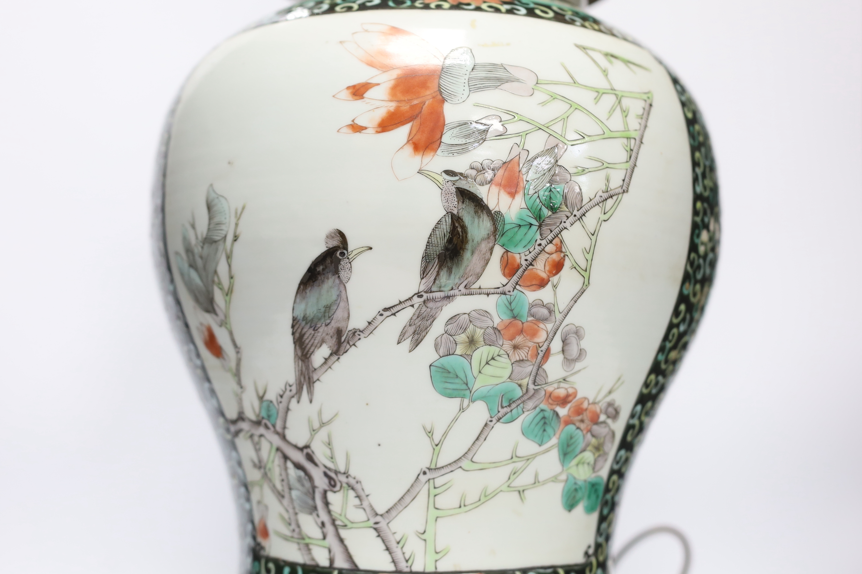 A Chinese famille verte porcelain baluster vase and cover, 19th century, decorated with birds amongst branches and blossom on decorative gilt metal base (now converted to a table lamp and drilled), 56cm total